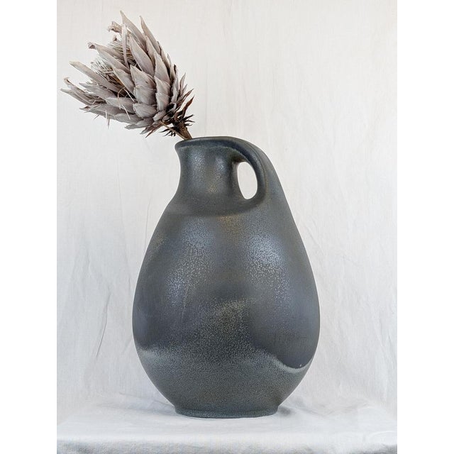 Large blue ceramic vase with a handle. Clean German design with a mark underneath that I can't identify. A beautiful...