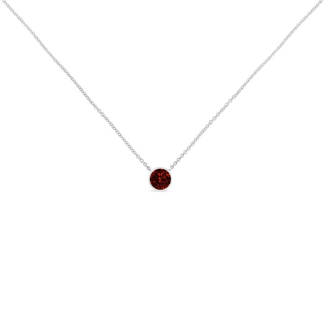 This simple and stunning ruby pendant is crafted in cool .925 sterling silver. Dangling from a cable chain, a glittering...