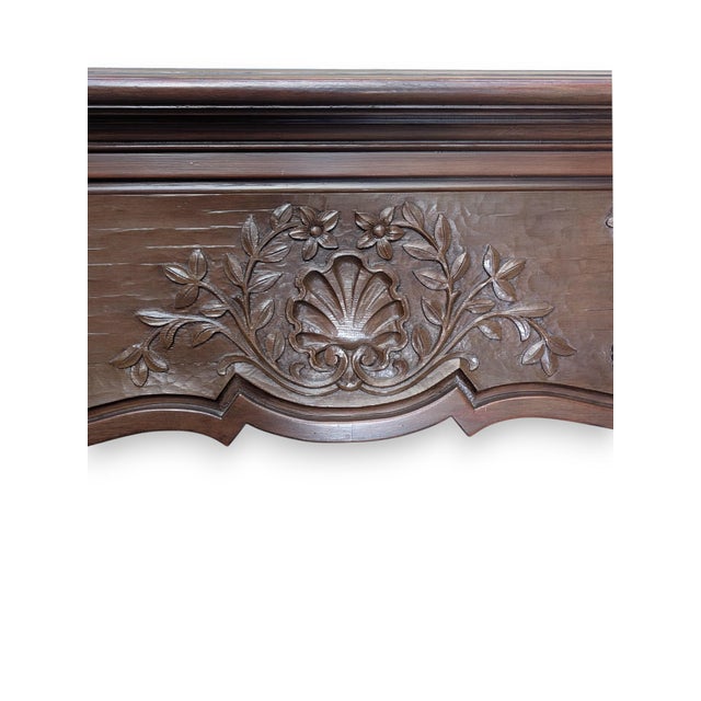 Vintage Douglas Fir fireplace surround with an acorn, flower and berry motif on the mantel header. The surround is made of...