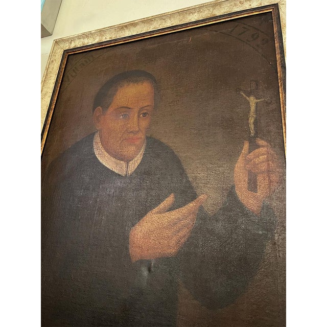 This oil on canvas is of Padre Andrea Villani (1706-1792). The piece is housed in a light cream and brown frame.