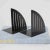 Striking pair of vintage post-modern bookends crafted from sleek black metal. Featuring a bold triangular grill design,...