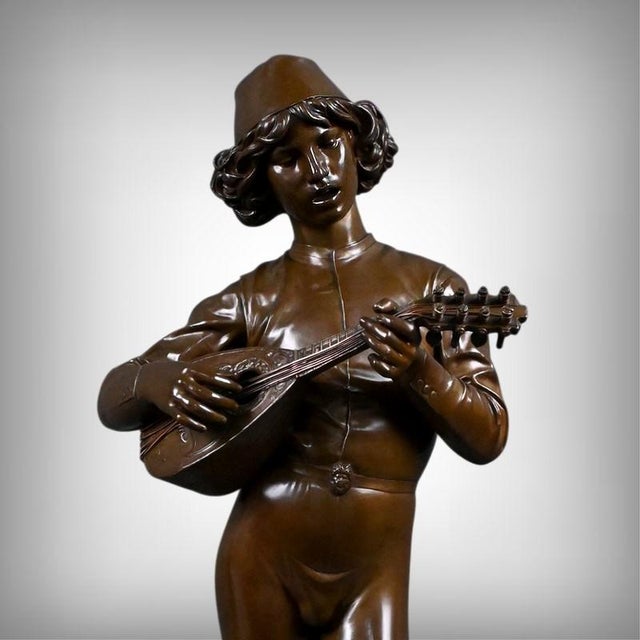 Elegant and vibrant with life, this bronze sculpture with a brown patina, signed "p. Dubois, 1865," embodies the full...