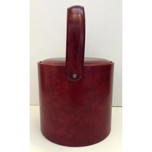 The party is not over for this mid century classic. Vintage ox blood colored vinyl ice bucket by George Briard with...