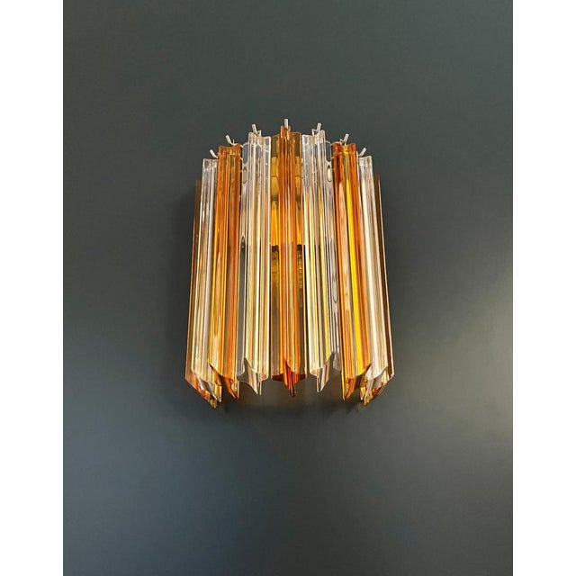 Fantastic pair of vintage Murano wall sconce made by 9 Murano clear and amber crystal prism (quadriedri) for each applique...
