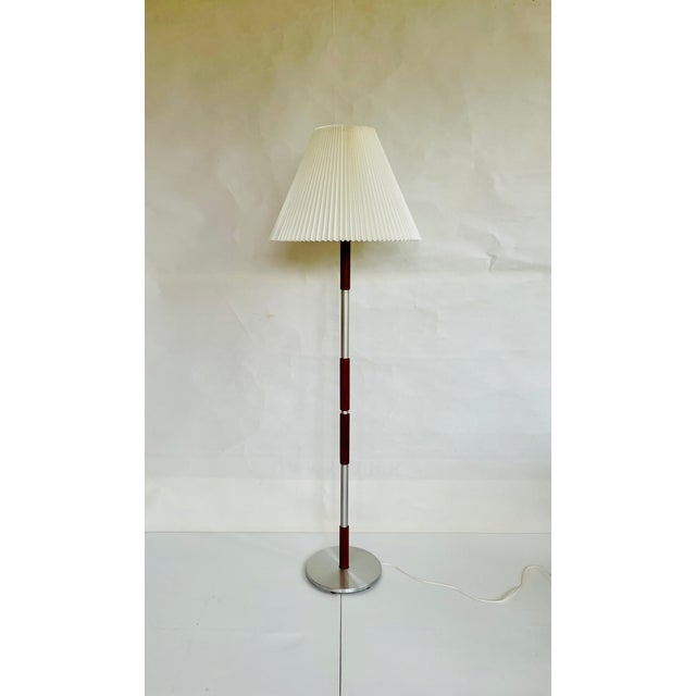 Vintage floor lamp from Denmark approx. 1960s. Mid-century modern design in aluminum and teak with adjustable lamp rod....