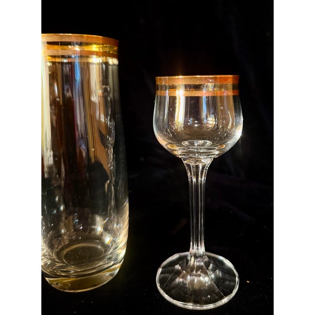 This collection features a variety of vintage fine Bohemian Geneva crystal glassware, distinguished by elegant gold-rimmed...