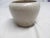 White ribbed shoulder vase in the HOMESPUN or STONEAGE style by Zanesville Pottery. The Vase is 4" h x 5.5" in diameter....