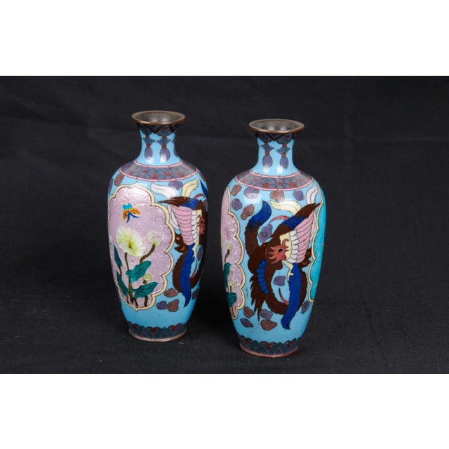A stunning pair of 7.25" Japanese Akasuke enameled vases. Each vase has two cartouches on the sides. One yellow with...