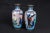 A stunning pair of 7.25" Japanese Akasuke enameled vases. Each vase has two cartouches on the sides. One yellow with...