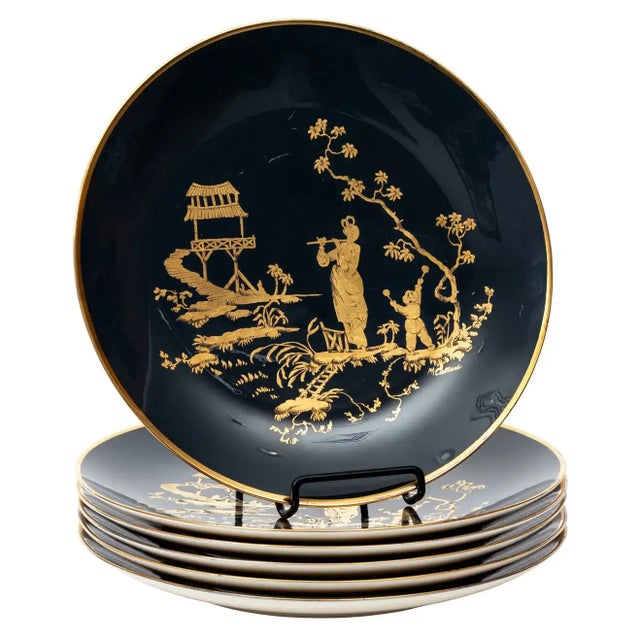 Circa mid-20th century set of six porcelain Chinoiserie style plates by Carole Stupell. The plates feature a deep teal...