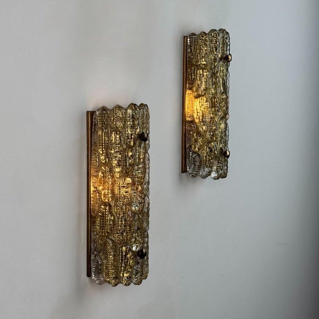 A sculptural pair of wall lights by Carl Fagerlund for Orrefors, Sweden, circa 1970s. Each sconce features a thick,...