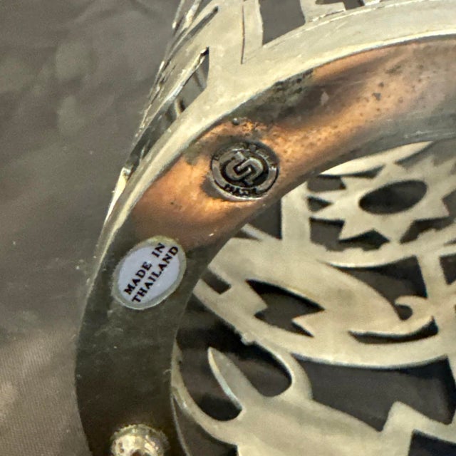 The Kachina Candle Holder is a stunning cobalt blue glass vase wrapped in a pewter hurricane, standing at a height of 10...