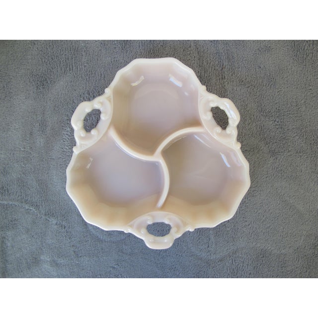 Cute pink relish tray or candy dish. A little over 8" wide. I love the details in the handles.