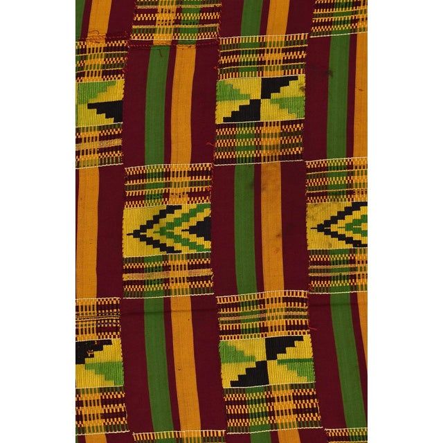 This textile contains colors of green, yellow, red, and black. The estimated age is more than 40 years. Kente cloth is the...