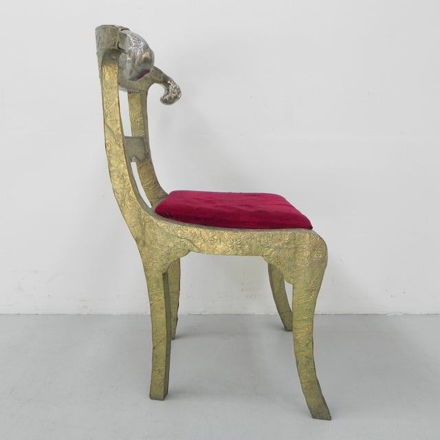 This chair was made in India in the early 20nd century for the European market. There are brass ram heads on both sides of...