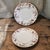 This product is a pair of vintage Minton fine porcelain plates with an ancestral pattern in a floral design. Made in...