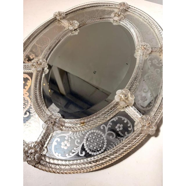 Elegant Venetian wall mirror crafted with refined etched floral motifs and delicate hand-applied glass flower decorations....