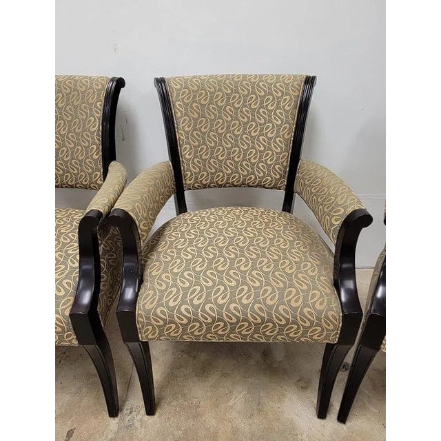 The 1970 Set of 4 Baker Ebonized Neoclassical Arm Chairs are fully assembled and feature a sleek black color, making them...