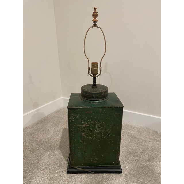 Charming Antique English Tole Tea Cannister wired into a lamp with a wooden base and weighted on the inside. This...