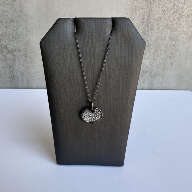 Enhance your jewelry collection with this exquisite Diamond Disc Necklace in 14kt Gold with Black Rhodium Plating....