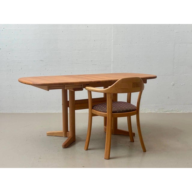 A characterful vintage dining table from design + handwerk, crafted from alder wood. The table combines a clean,...