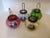Fabulous set of four fun vintage colored glass lanterns with black metal handles in very good condition consistent with...