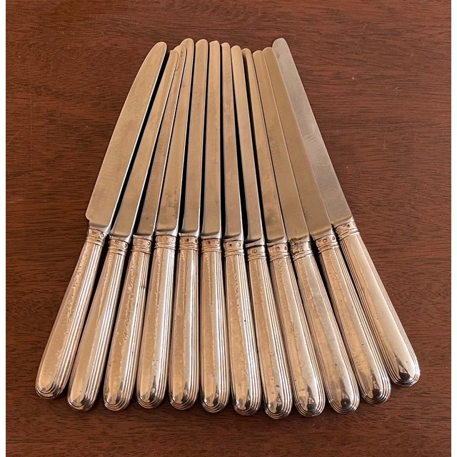 Set of twelve late 18th century English George III silver handled dinner knives hallmarked for John Lambe, London. Each...