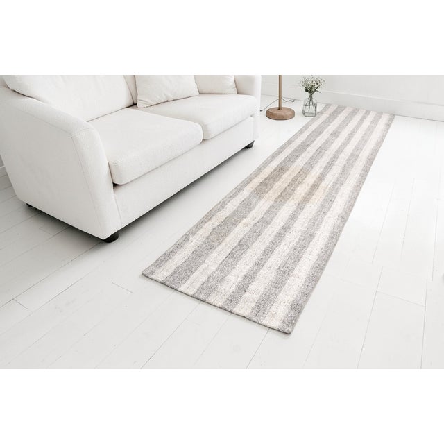 This is a vintage Turkish Oushak rug from the Mid 20th Century. The piece was hand-knotted.