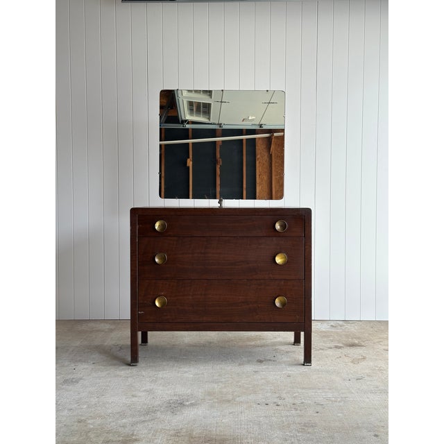 Vintage Art Deco three-drawer steel chest by Norman Bel Geddes, defined by its architectural frame, rounded edges, and...