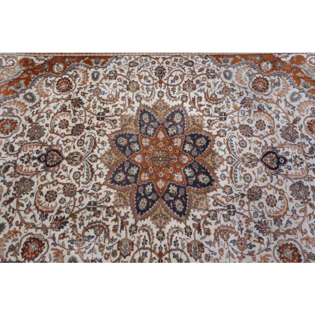 Hand-knotted Indian rug from Jaipur. The central field features a Herati pattern and a central medallion with palmettes,...
