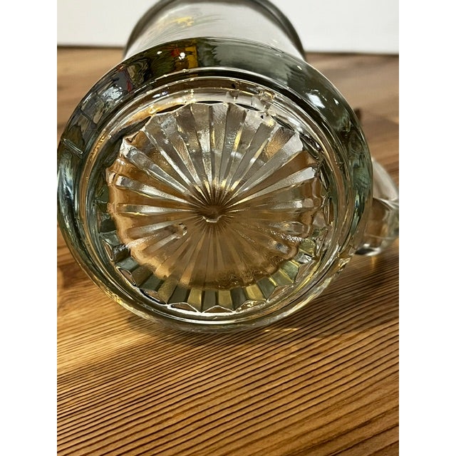 This is a vintage German crystal or clear glass beer stein featuring a hand-painted Bavarian coat of arms with crowned...