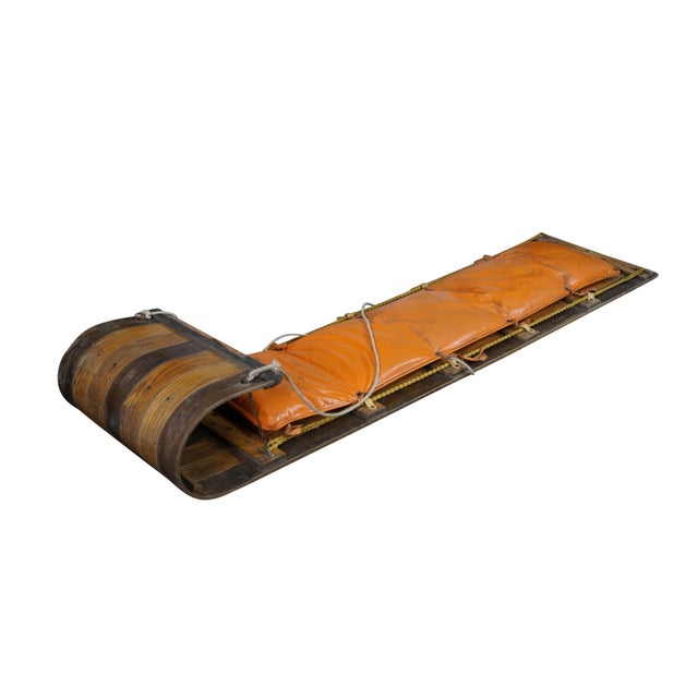 This vintage six-foot Adirondack toboggan showcases a classic, rugged winter aesthetic crafted from durable, natural oak...