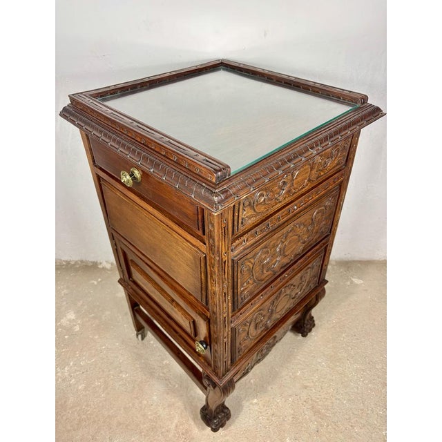 Exceptional Renaissance oak tea trolley cabinet featuring richly carved decoration, a glass inset top, side storage...
