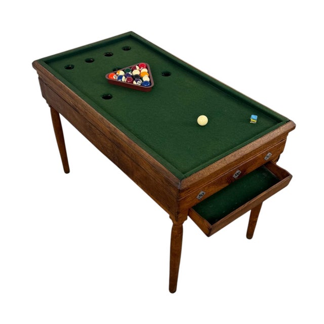 A charming antique child’s billiard table crafted from solid oak, dating from the late 19th to early 20th century. This...