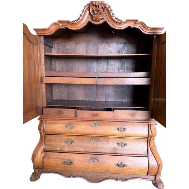 Gorgeous Dutch 19th century armoire with lovely carving on the bonnet. The paw feet are fabulous.