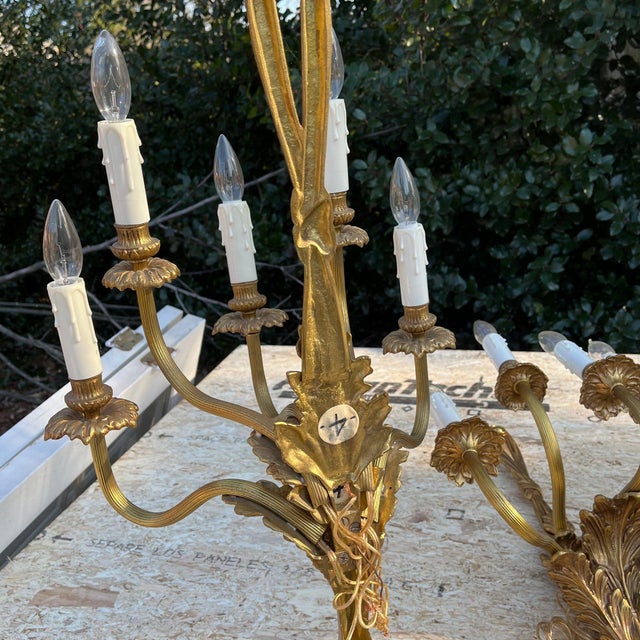A pair of heavy ornate gilt bronze Rococò style wall sconces with scrolling arms, floral bobeches, acanthus leaf detailing...