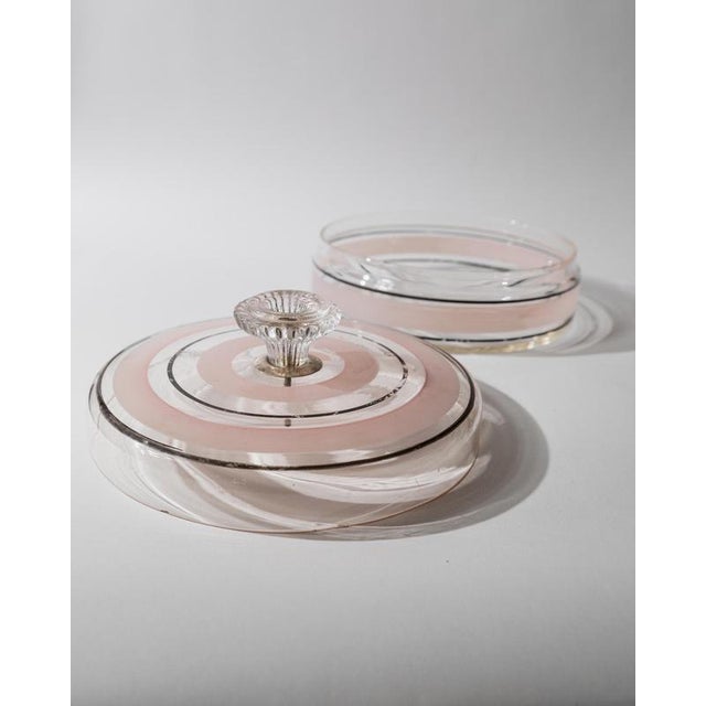 This vintage glass bonboniere from the 1960s is a charming example of Italian art glass, combining elegant craftsmanship...