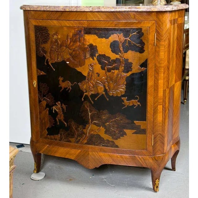 French Louis XV style kingwood commode, circa early 1900s. The shaped marble top conforms to the single door cabinet,...