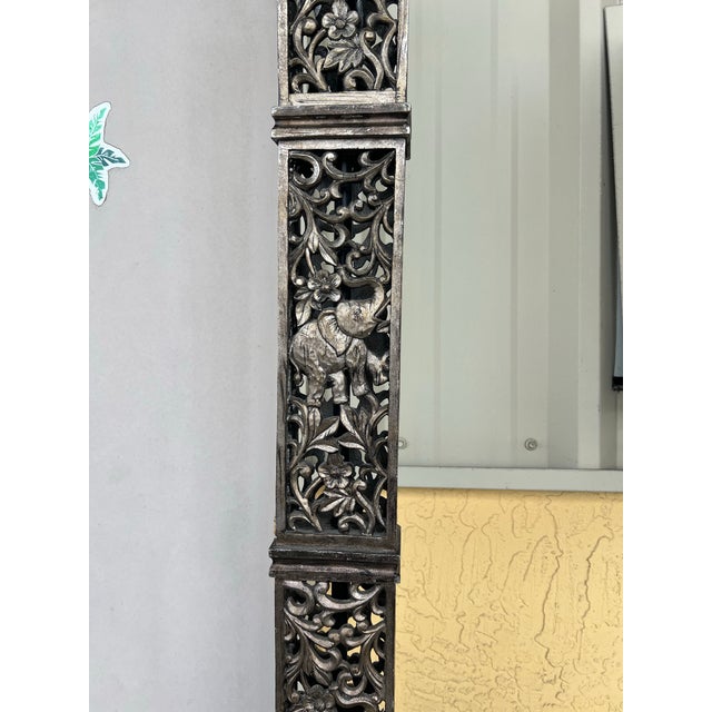 These lamps are tall, square columns with intricate, pierced carvings that prominently feature elephants. The design...
