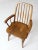 This is a Cochrane Furniture wooden arm chair circa mid-20th century . The Windsor style chair has modern styling with a...
