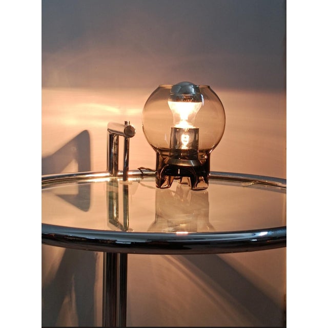 Beautiful table lamp by Sussmuth Leuchten. Germany, 1970s. All smoked clear glass, tripod base. The lamp holder is chrome-...