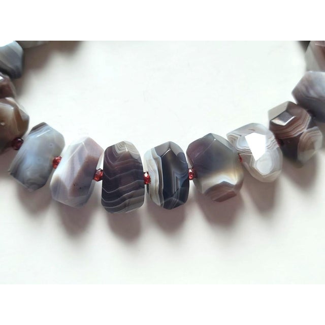 The length of the necklace is 17.5 inches (44.5 cm). The size of the beads is 13-16 mm x 17-19 mm. Botswana Agate is a...