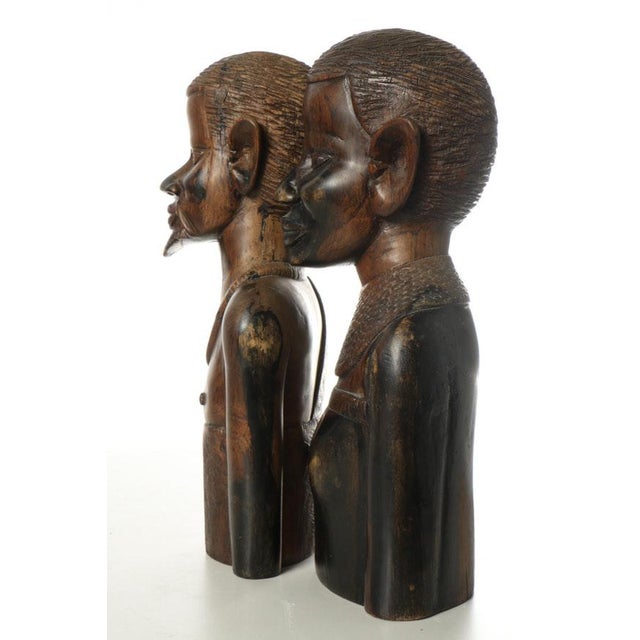 An awesome pair of wood carved African figures of male and female heads and torso. Beautiful patina and detail on these...