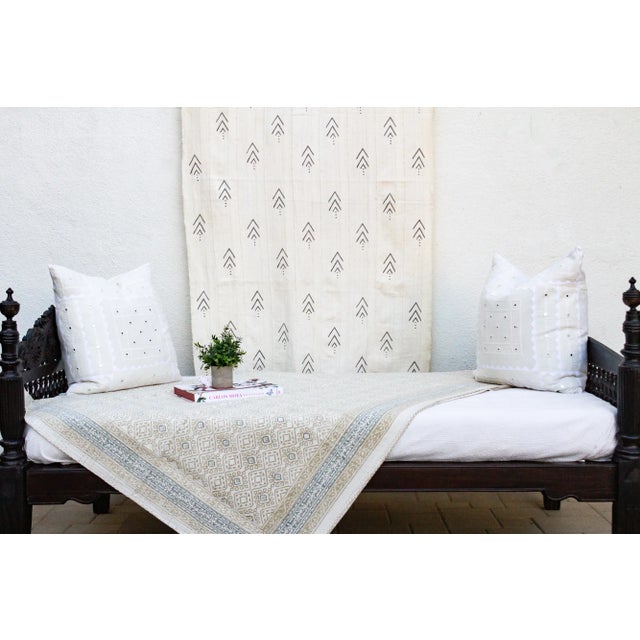 Inspired by traditional Indian kantha quilts, this cotton coverlet features a block-style print of tribal designs and...