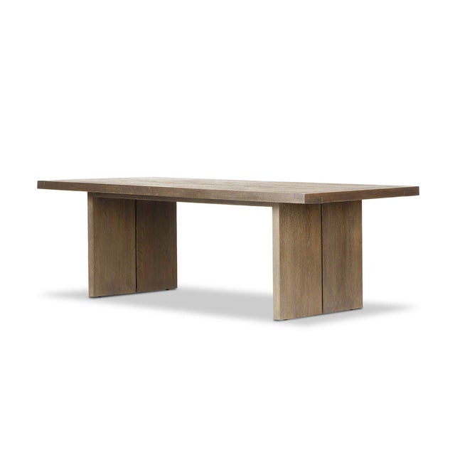 Worn oak shapes a streamlined dining table with a naturally minimalist look. Seats 8.