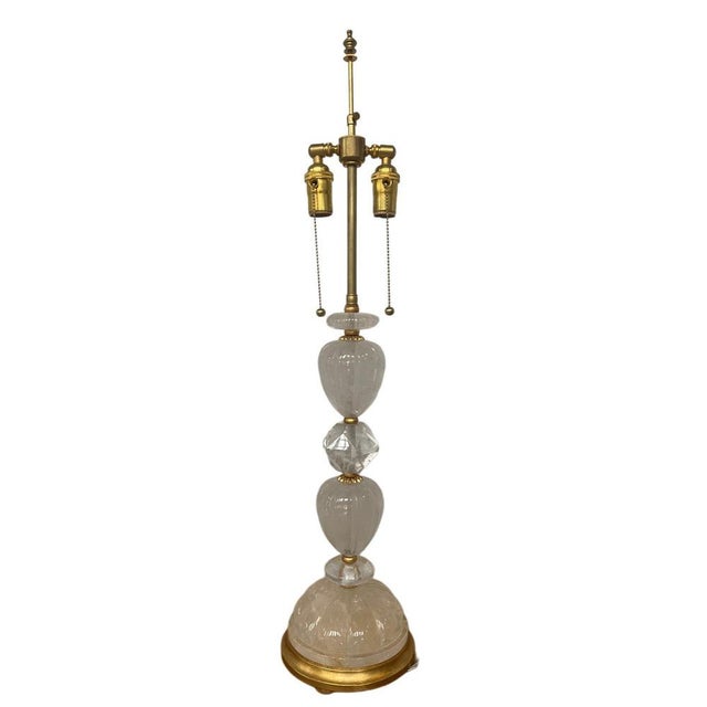 A sculptural vintage pair of table lamps composed of stacked carved rock crystal elements, including faceted and rounded...