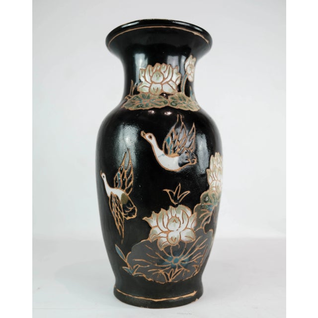 Ceramic vase with black glaze and decorated with flowers. The vase is in great vintage condition.