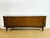 A 1940s french mahogany sideboard with contrasting legs, brass accents, and hardware. features four doors with integrated...