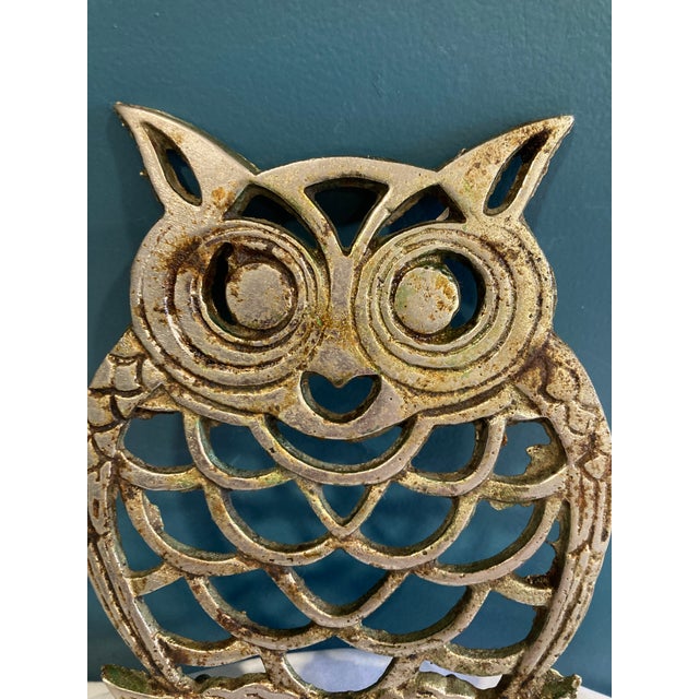 Cute mid-century brass trivet in the shape of an owl with feet.