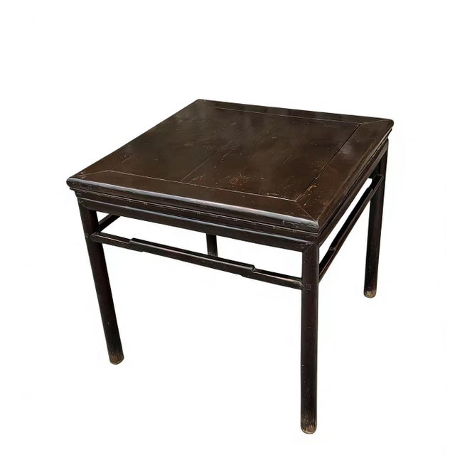 This 19th century square elm wood tea table is finished in a deep dark lacquer, showcasing a clean and minimalist...